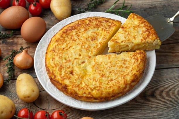 Tortilla Española Recipe — The real tortilla española — confited onions, olive-oil-poached potatoes, and a custardy center that sets