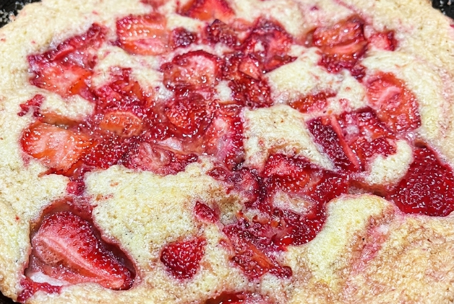 Skillet strawberry cake fresh from the oven with juicy baked strawberries