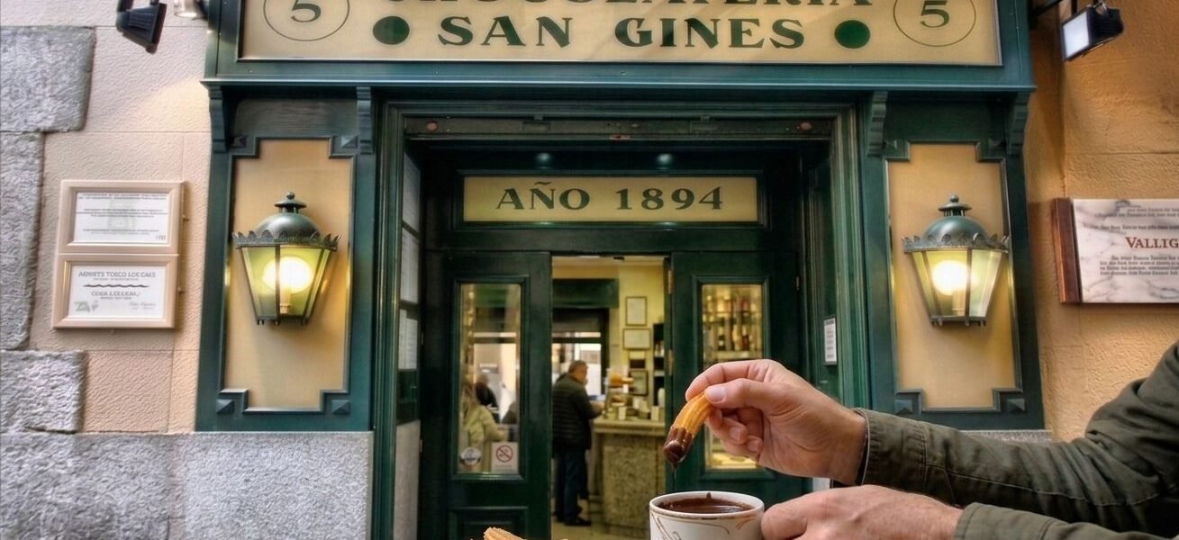 Warm churros served alongside a cup of thick Spanish hot chocolate for dipping