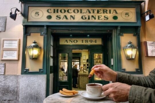 Warm churros served alongside a cup of thick Spanish hot chocolate for dipping